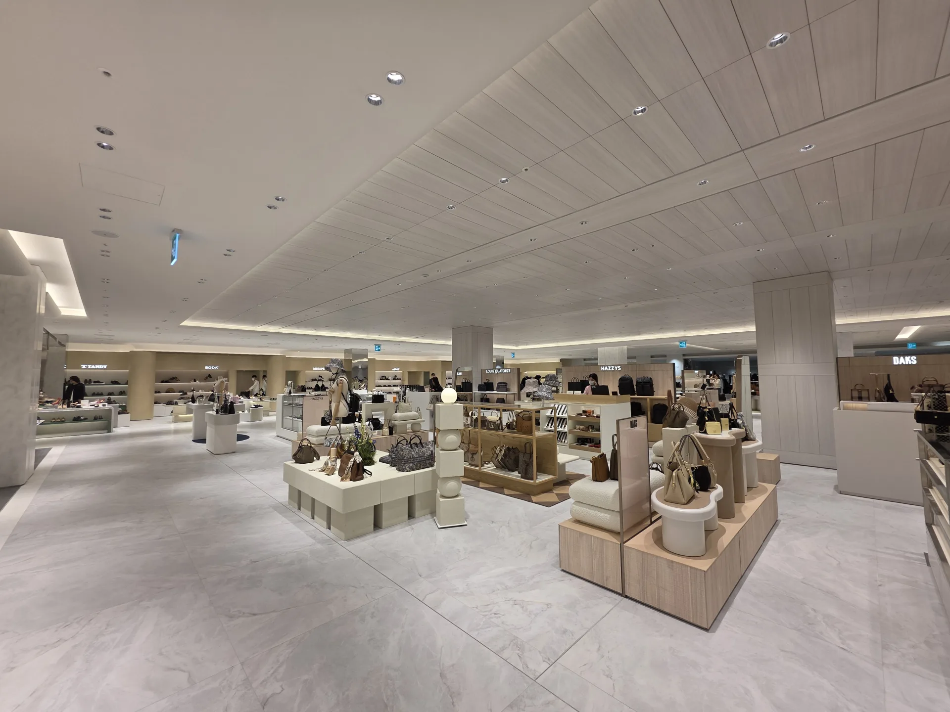 Open apparel display area featuring INTERO Recessed Downlights integrated into the architectural ceiling at Lotte Shopping Mall.