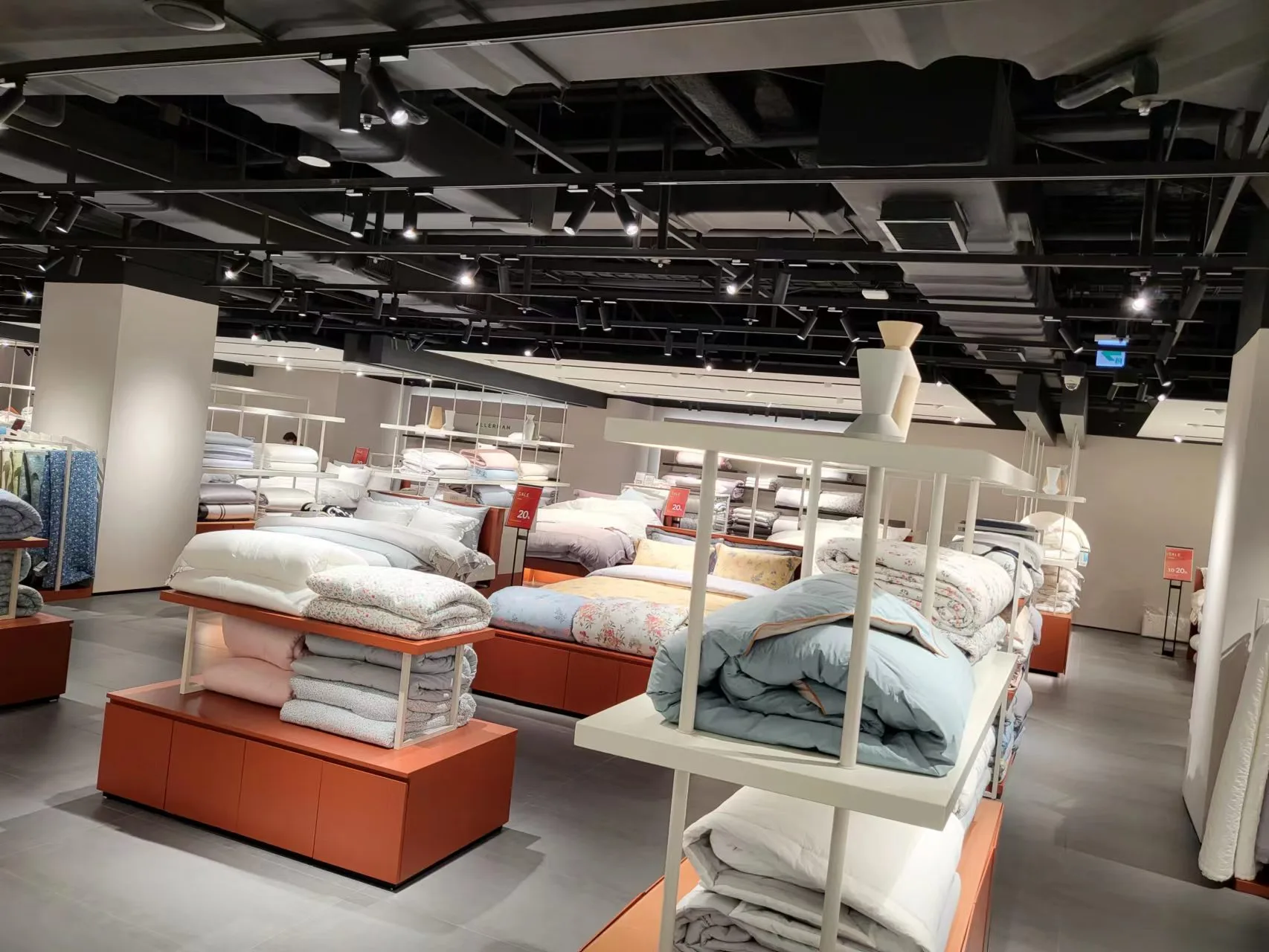 Bathroom and home living display illuminated with architectural lighting in Lotte Supermarket.
