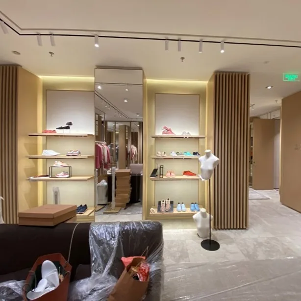 Luxury Loro Piana boutique entrance illuminated with architectural lighting.