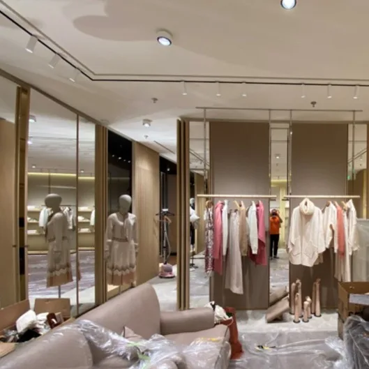 Retail display area featuring magnetic track lighting and recessed downlights.