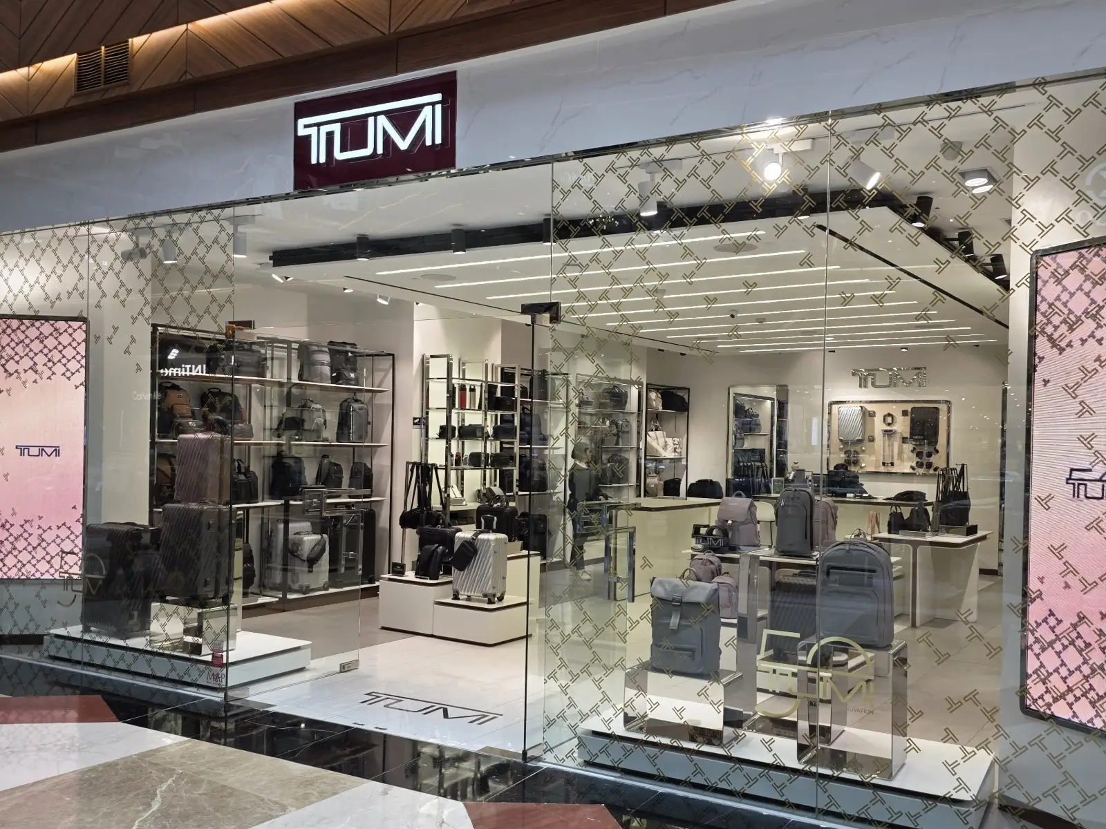 Interior of the TUMI Store in Jakarta illuminated with EMMA Track Lights, highlighting luggage displays and premium travel accessories.