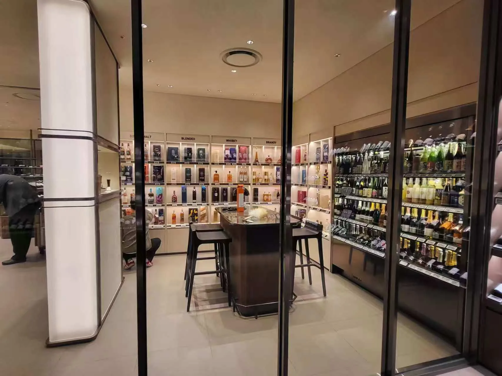 Interior tasting area at Lotte Duty Free illuminated with SOFT Recessed Downlights and illuminated display shelving.