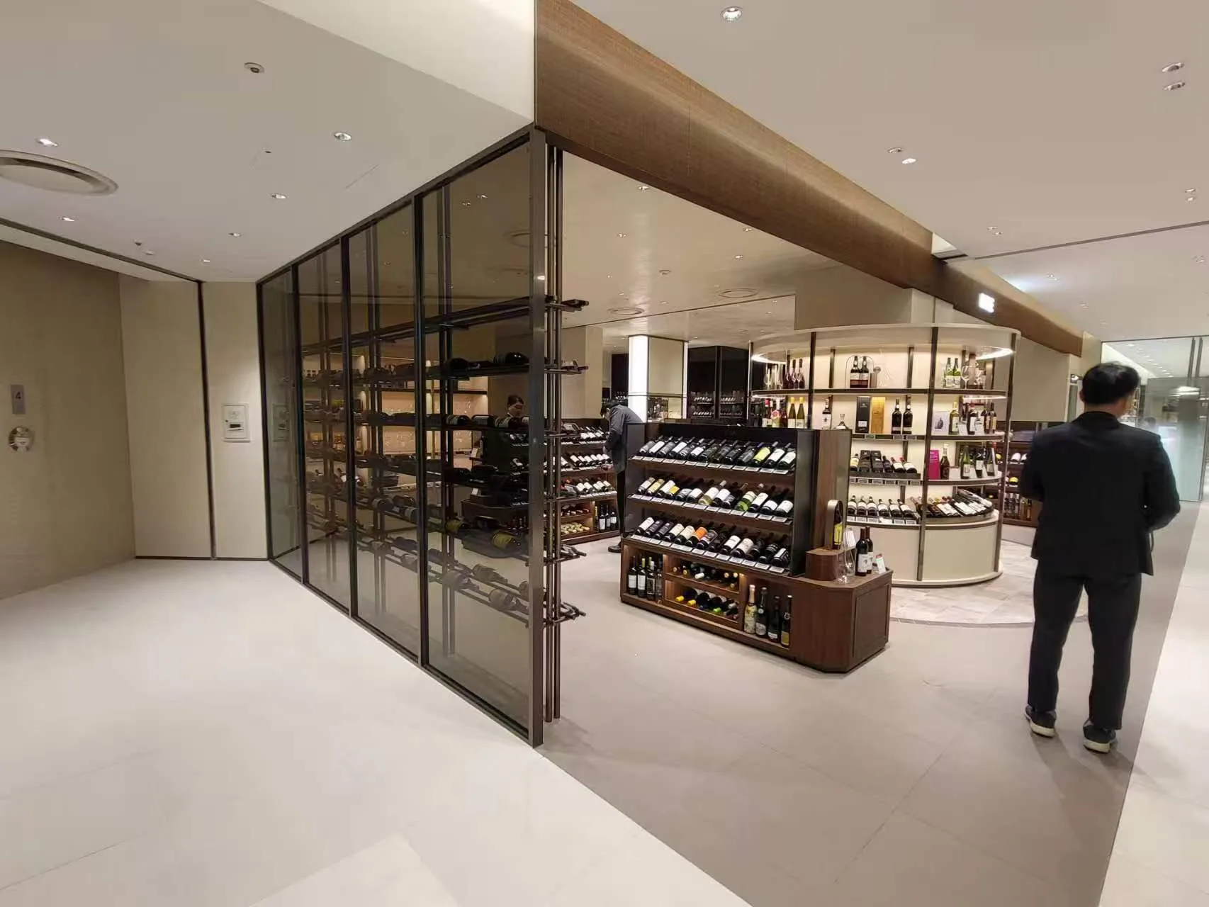 Luxury duty-free wine retail area featuring SOFT Recessed Downlights and ULTRA-SLIM Cabinet Lights.